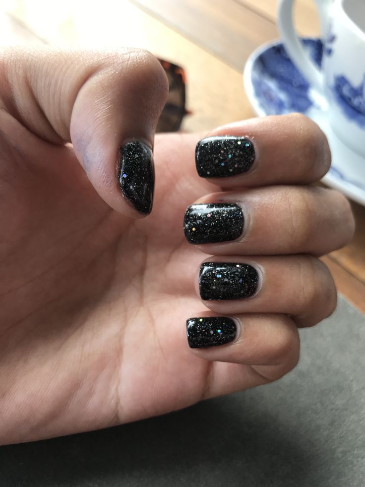 Glamorous Glittery Black Nail Design for Striking Elegance on Any Occasion.