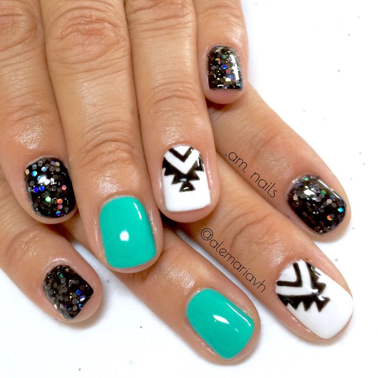 Vibrant Geometric Nail Design: Turquoise, Black, and White with Glossy Glitter Accents.