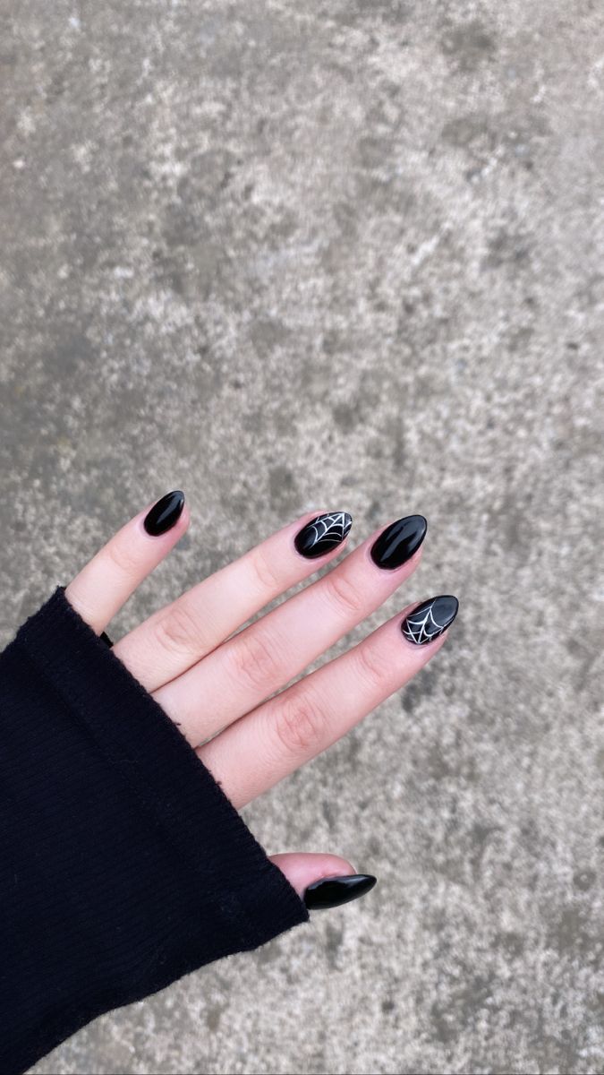 Gothic Nail Design: Glossy Black Polish with Elegant Spider Web Patterns for a Striking Look.