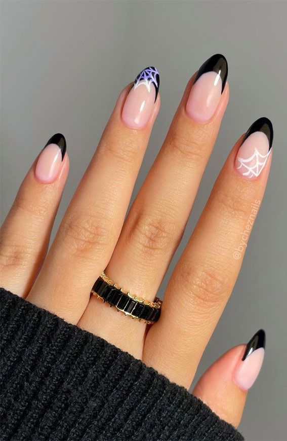 Chic Nail Art: Soft Pink and Bold Black Tips with Playful White Spiderwebs for a Modern Festive Look