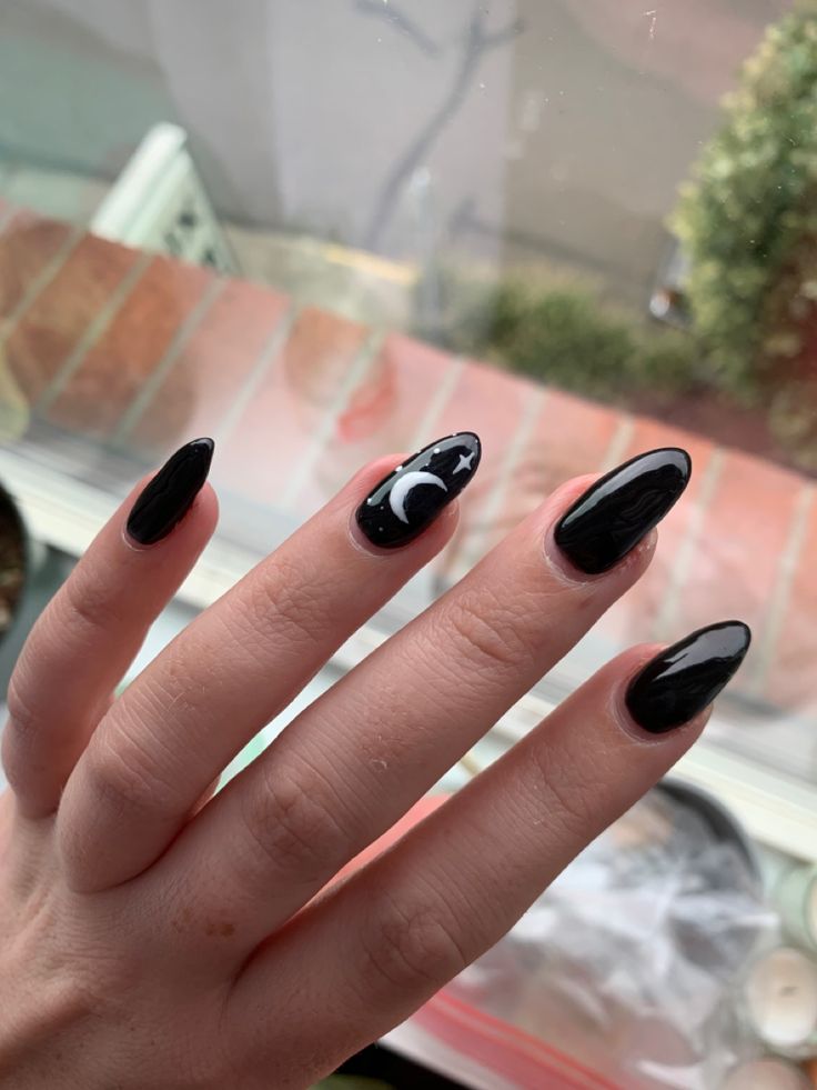 Chic Celestial-Inspired Black Nail Art with Crescent Moon and Star Accents.