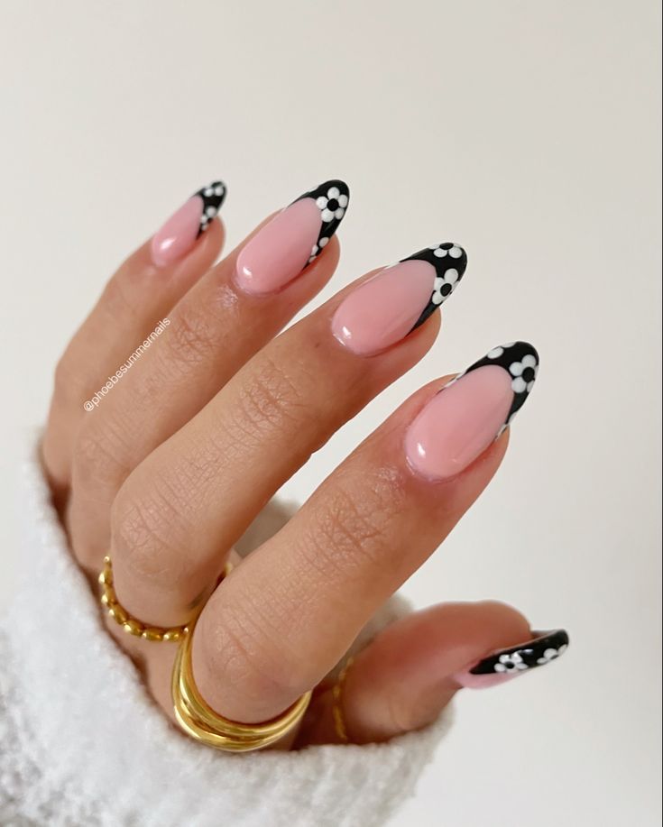 Elegant Soft Pink and Black Nail Design with Playful White Polka Dots