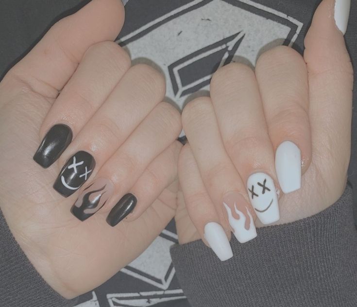 Edgy Black and White Nail Art with Flame Accents and Graphic Faces