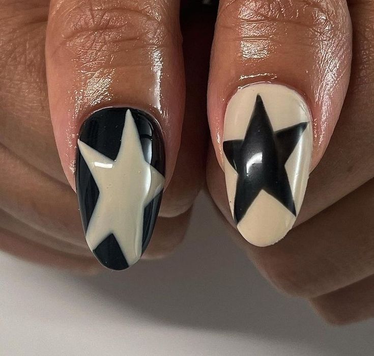 Bold Black and Cream Star-Themed Nail Design: A Modern Statement Look.