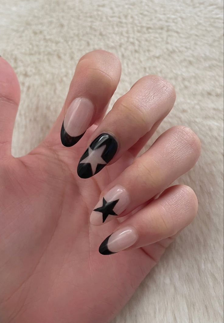 Chic Nude and Black Nail Design with Stylish French Tips and Bold Star Motifs