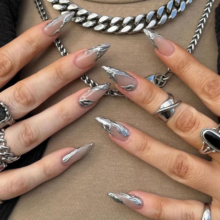 Chic Metallic Nail Design with Elongated Shapes and Nude-Silver Marbling.