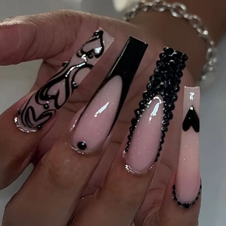 Artistic Nail Design: A Striking Blend of Soft Pink and Bold Black with Intricate Patterns and Glossy Finishes