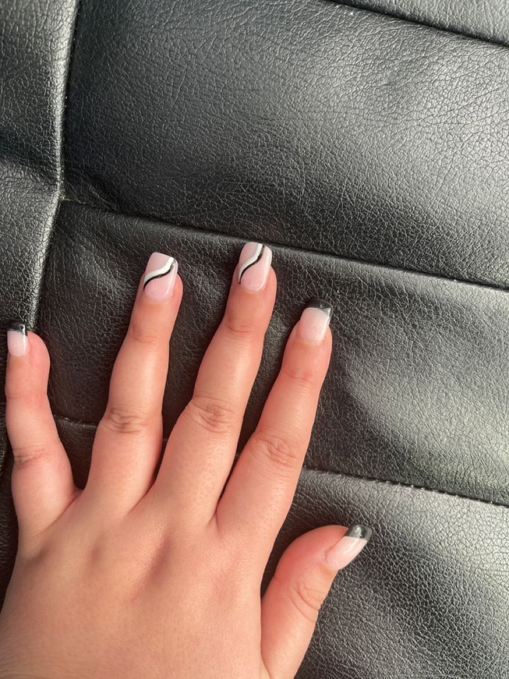 Chic Black and White Nail Design with Elegant Curves for Bold Sophistication.