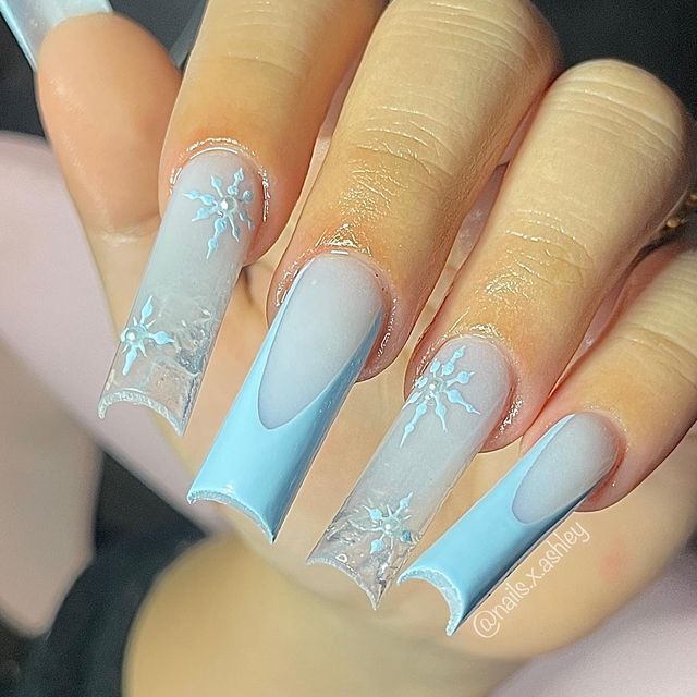 Sophisticated Winter-Themed Nail Design with Frosted Blue Shades and Snowflake Patterns.