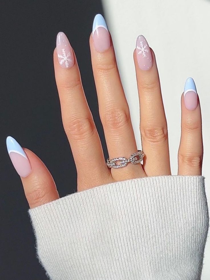 Chic Winter Nail Design with Pastel Pink and Blue, Enhanced by Pointed Tips and Elegant Snowflake Accent.