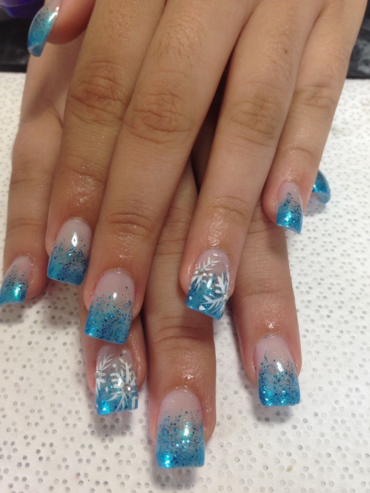 Enchanting Frosted Nail Design with Icy Blue Gradient and Snowflake Patterns for Winter Celebrations.