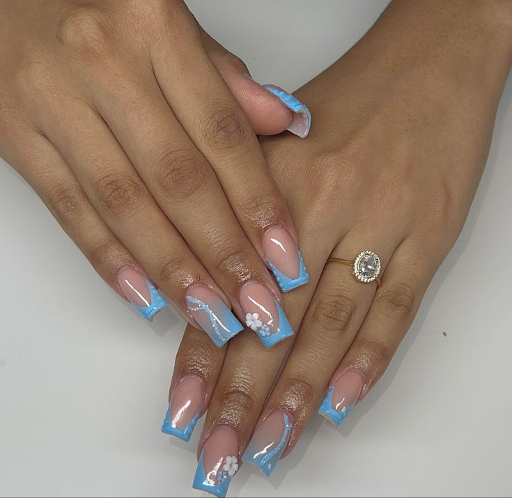 Chic Soft Pink and Blue Nail Design with Whimsical Floral Accents.