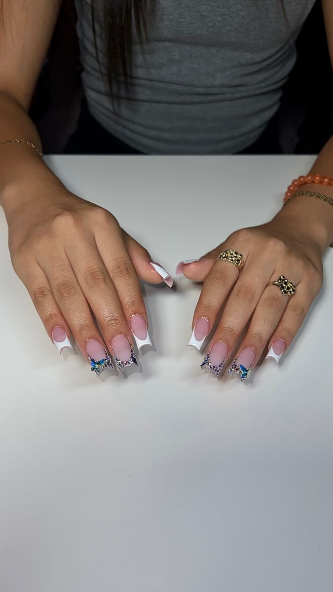 Whimsical Sophistication: Elegant Pink and White Butterfly Nail Design with Sparkling Embellishments