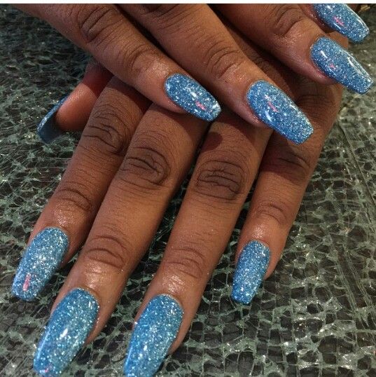 Dazzling Sparkling Blue Nail Design with Elongated Tapered Tips for Glamorous Elegance.