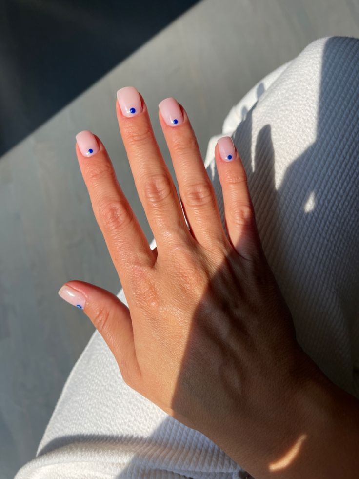 Modern Elegant Nail Design with Soft Pink Base and Minimalistic Blue Accents