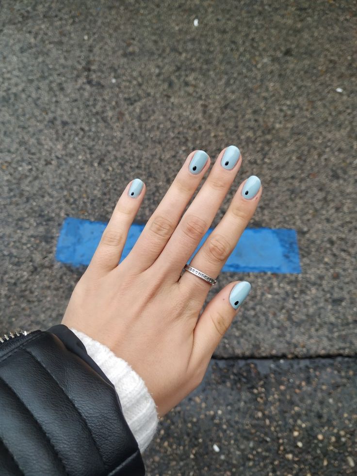 Chic Minimalist Blue Nails with Black Dots: A Modern and Playful Trend.