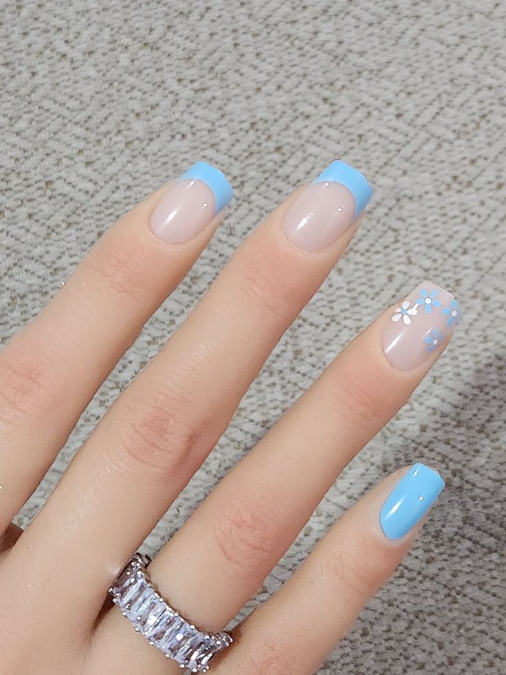 Chic Beige and Light Blue Nail Design with Floral Accents for Spring/Summer.