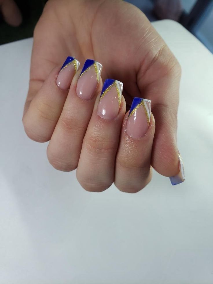 Elegant Geometric Nail Design: Soft Nude and Vibrant Blue with Gold Accents.