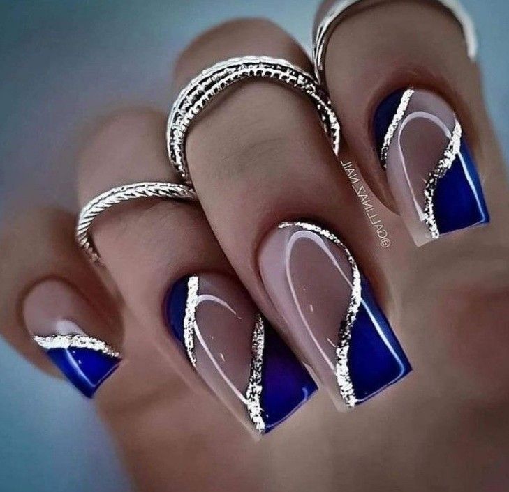 Chic Nail Design: Glossy Blue and Nude with Silver Lines and Delicate Rings.