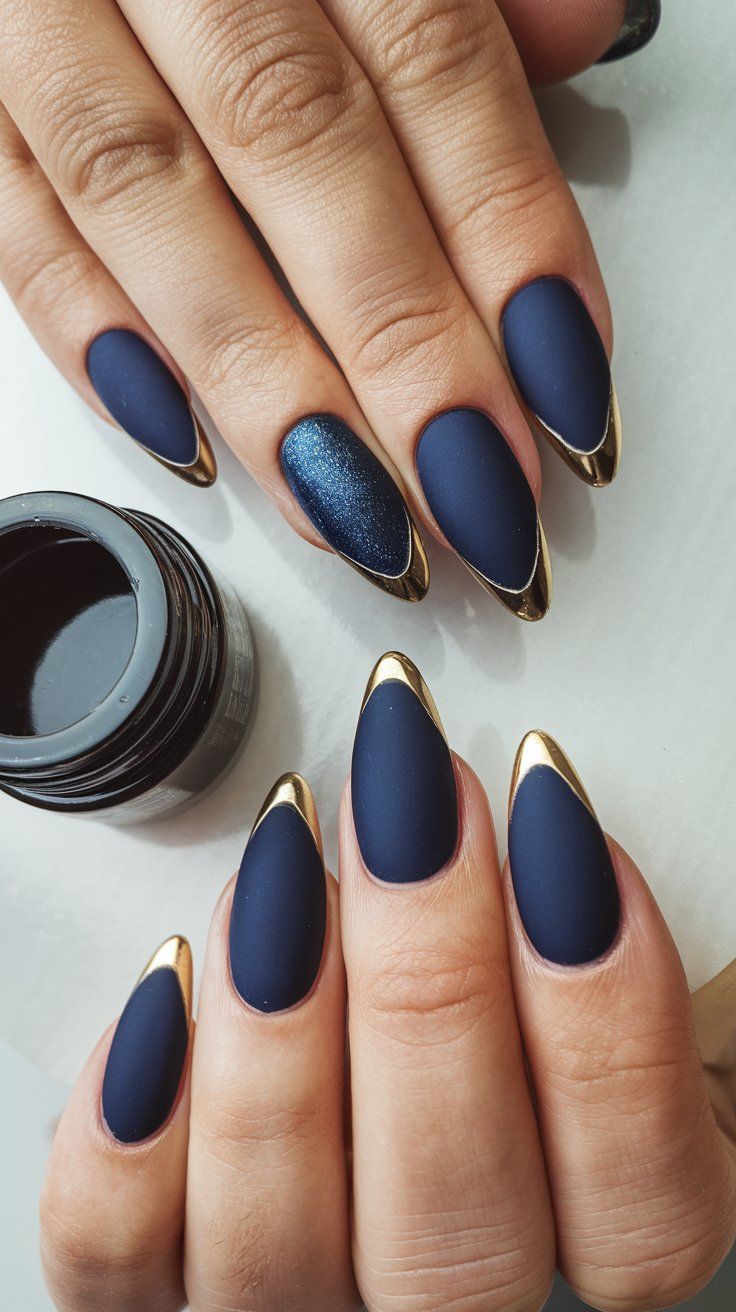 Sophisticated Navy Matte Nail Design with Gold Tips and Shimmering Blue Accent.