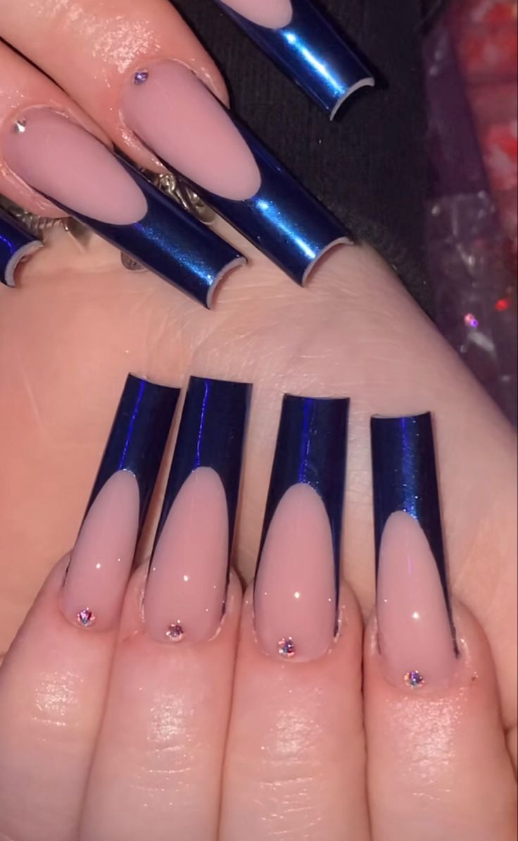 Chic Split Nail Design: Glossy Deep Blue Tips and Soft Nude Base with Rhinestone Embellishments.