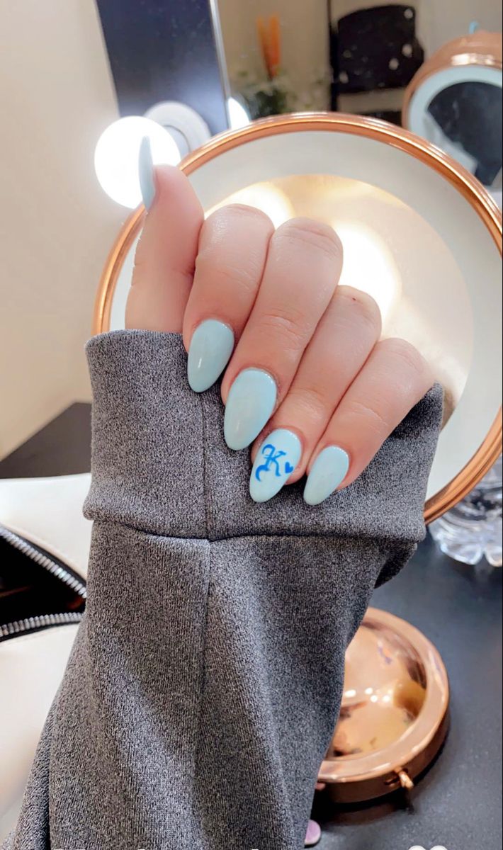 Chic Soft Pastel Blue Almond Nails with Playful Accent Design for Any Occasion