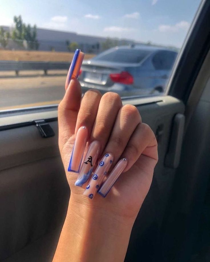 Whimsical Lavender-Tipped Acrylic Nails with Blue Polka Dots and Personalized Lettering.