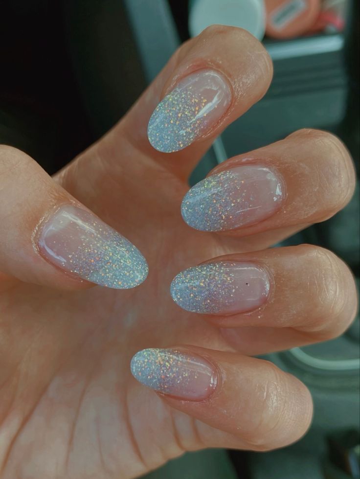 Elegant Ombre Glitter Nail Design with Soft Blue Gradient Tips.