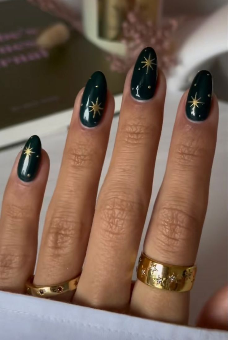 Celestial Chic: Elegant Nail Art with Deep Green Base and Gold Star Designs.