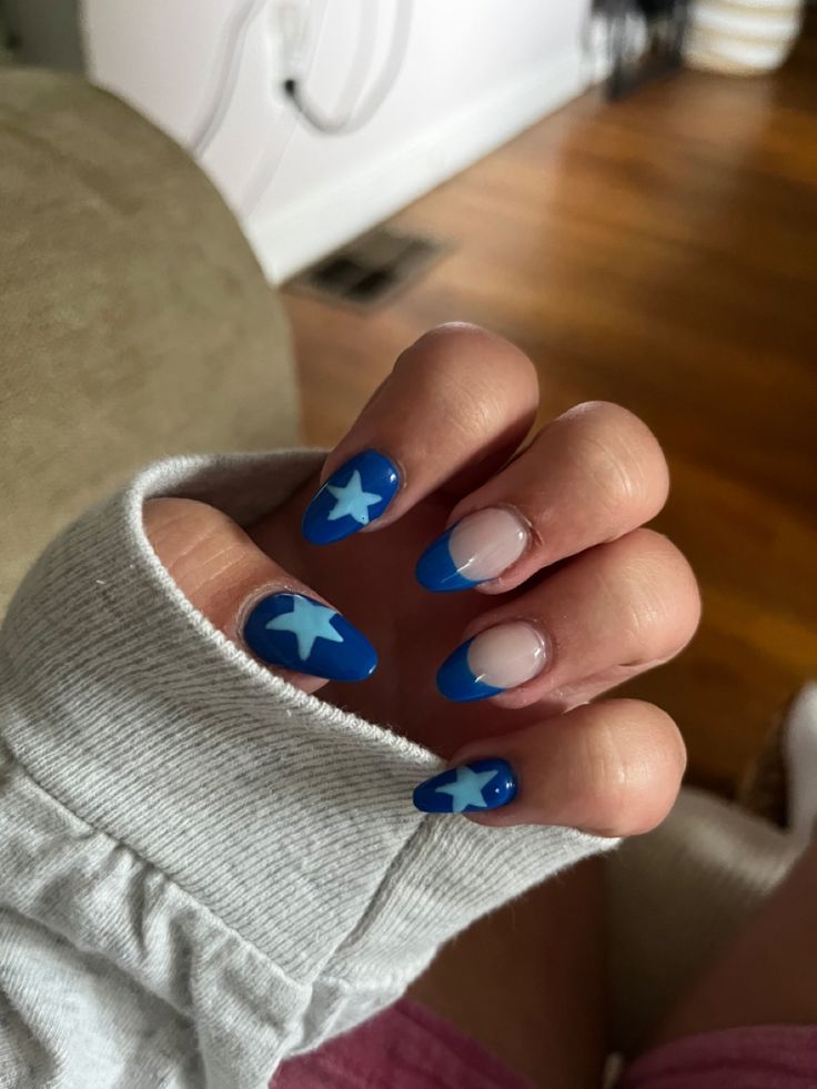 Vibrant Blue Star-Tipped Nail Design: A Playful Yet Polished Aesthetic.