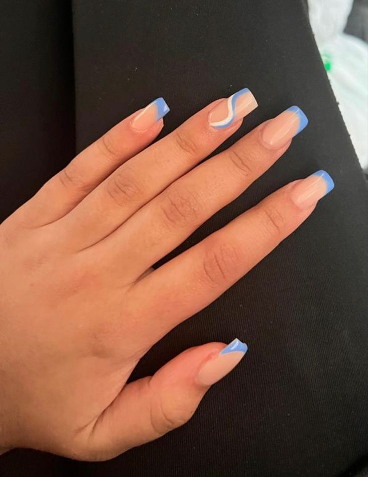 Trendy Pastel Blue French Tip Nail Design with Unique Swirling Accent.