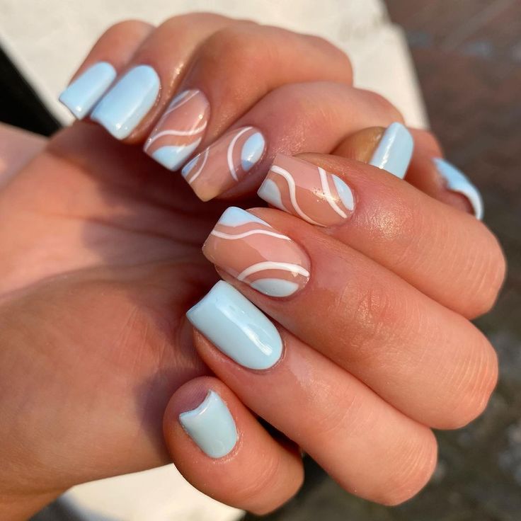 Playful Pastel Blue Nails with Abstract Designs and Wavy Accents for a Modern Aesthetic.