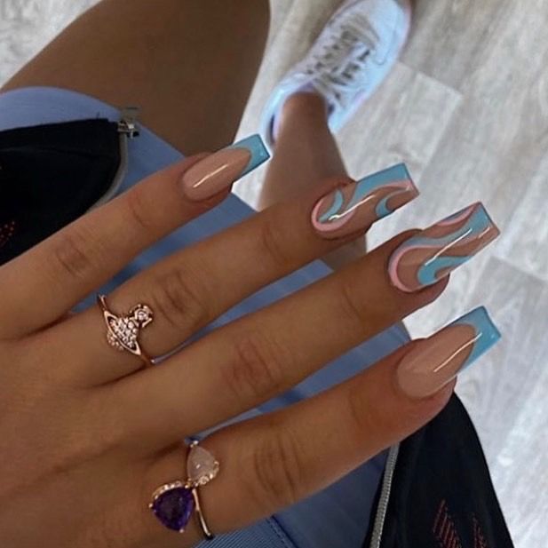 Trendy Long Nails with Nude and Pastel Blue Wave Design, Paired with Elegant Rings.