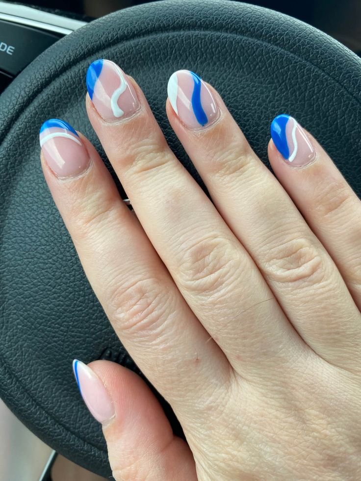 Elegant Blue and White Swirl Nail Design: A Fresh and Stylish Blend of Colors.