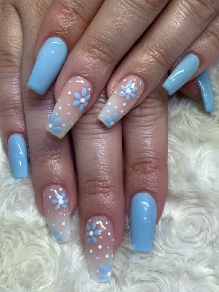 Whimsical Delicate Blue Nail Design with Ombre and Floral Accents for Spring/Summer.