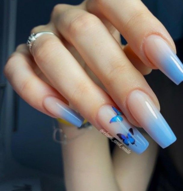 Whimsical Ombre Blue Nail Design with Butterfly Accents on Long Square Tips