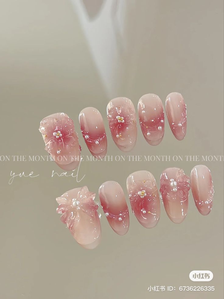 Elegant Floral Nail Design with Pastel Pink Tones and Ombre Effect