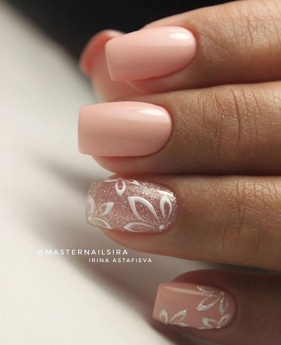 Elegant Soft Pink Nail Design with Floral Accents for a Stylish Look.