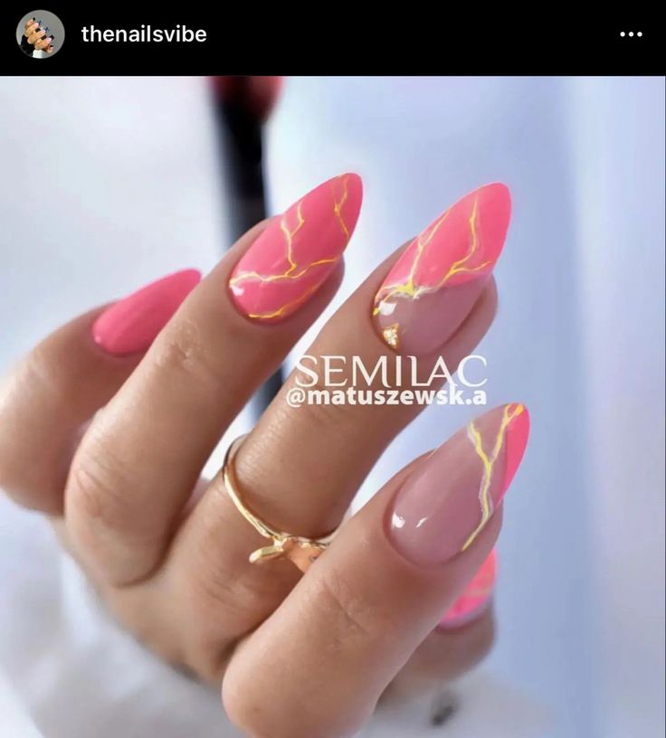 Modern Artistic Nail Art: Vibrant Pink with Gold Accents in Elegant Almond Shape.