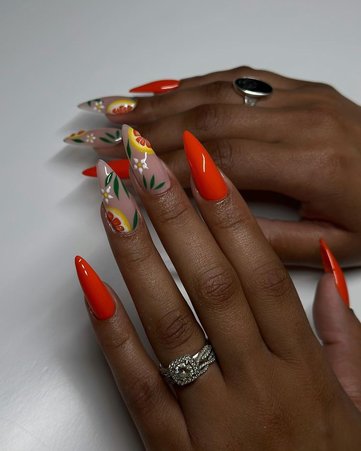 Bold Floral Nail Design with Neon Orange and Pastel Pink Accents