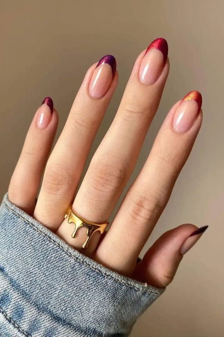 Chic Gradient Nail Design with Deep Purple and Vibrant Orange Tips, Accented by a Delicate Gold Ring.