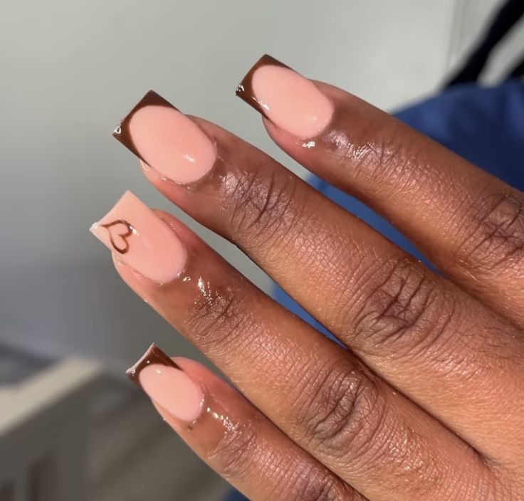 Elegant Nude and Brown Nail Design with Heart Accent and Contrasting Tips