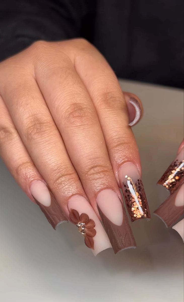 Chic Earthy Tone Nail Design with Glossy Brown Base and Floral Accents