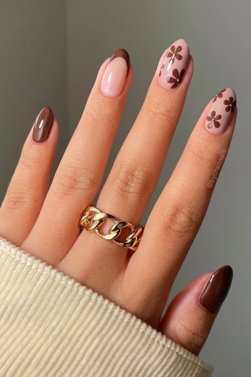 Chic Nail Design: Warm Brown and Soft Pink Hues with Playful Floral Patterns.