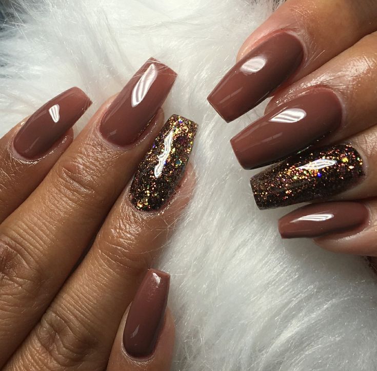 Sophisticated Earthy Brown Nail Design with Glittery Accent for Glamour and Fun.