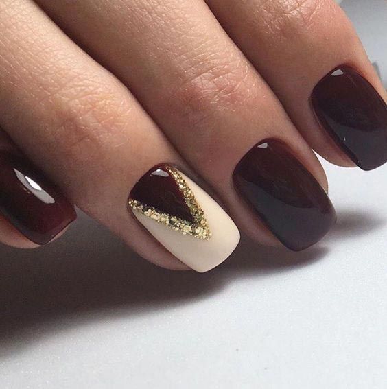 Chic Burgundy and Nude Nail Design with Glamorous Gold Glitter Accent.