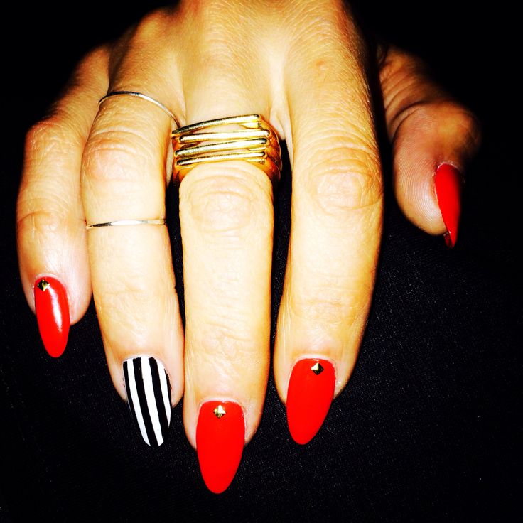 Chic Bold Nail Design with Glossy Red, Striking Black-and-White Stripes, and Elegant Gold Accents.