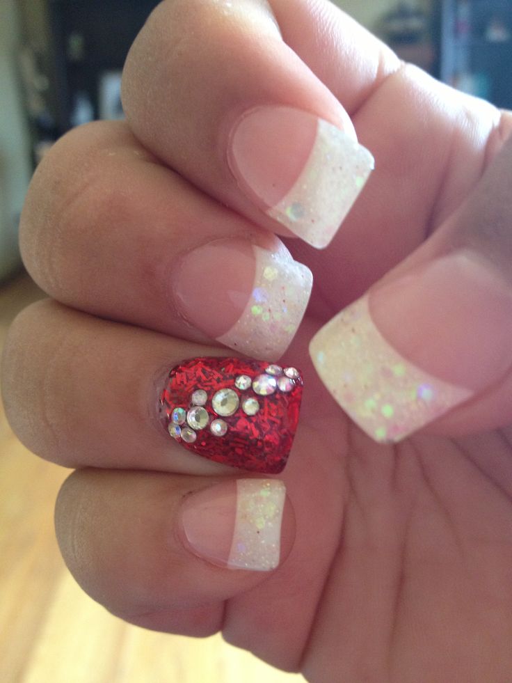 Chic French Tip Nail Design with Glittery Accents and Glamorous Rhinestones.