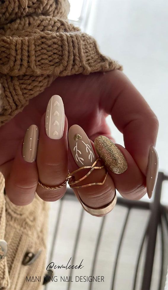 Chic Beige Floral Nail Design with Gold Glitter Accents and Minimalist Dots.