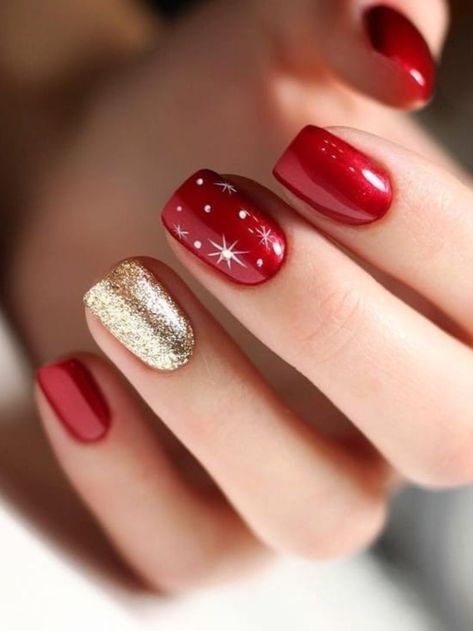 Glamorous Glossy Red Nails with Gold Accents and Whimsical Star Designs for Festive Celebrations.